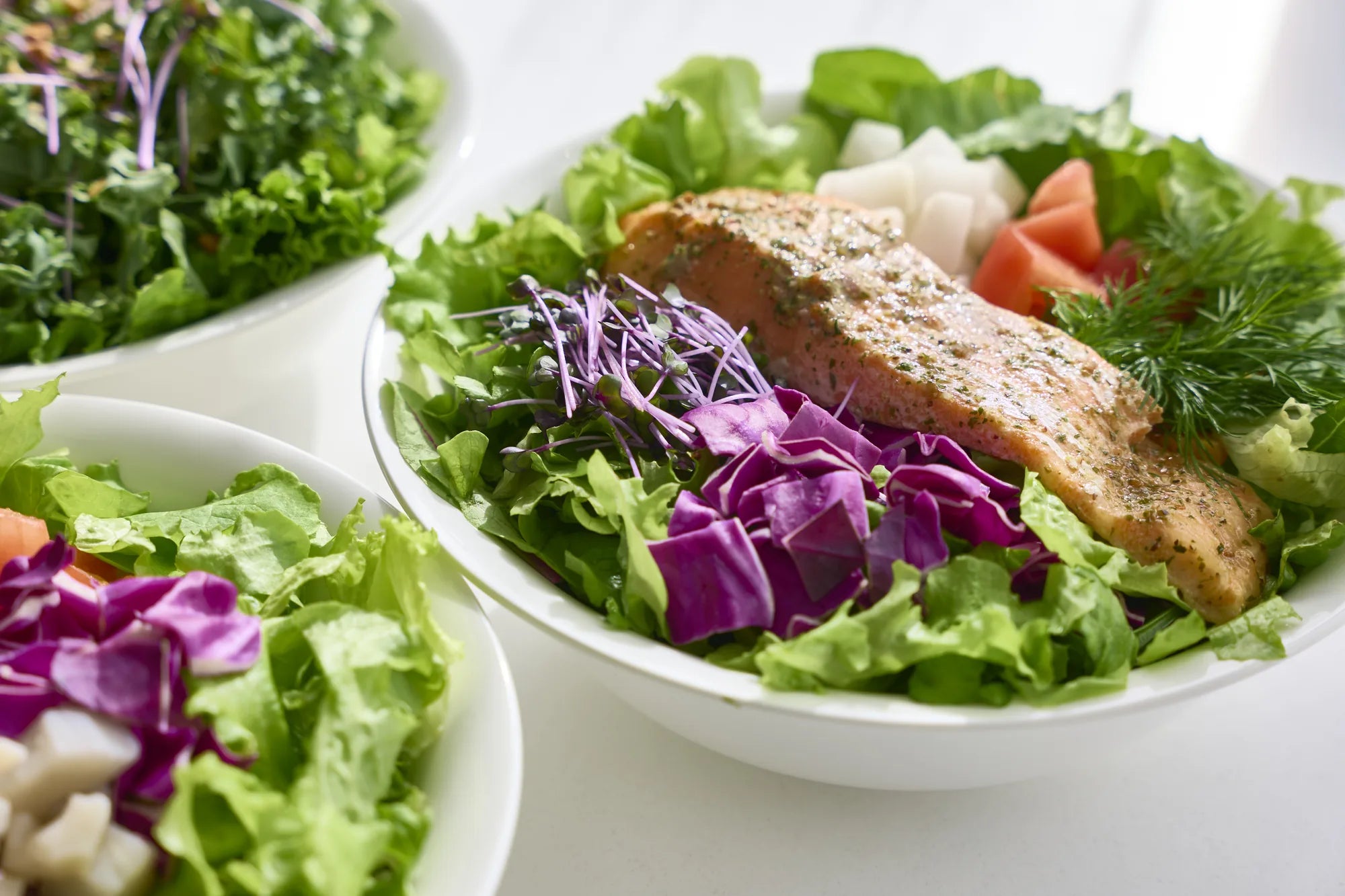Seared fish over fresh greens, plated